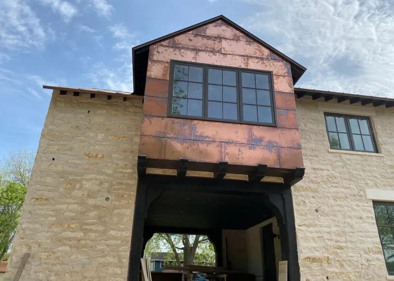 Copper metal panel facade on a stone building for Skylight Installation in Mount Dora